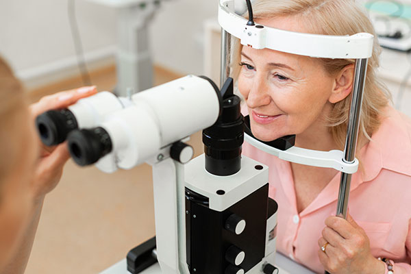 woman smiling during an eye exam